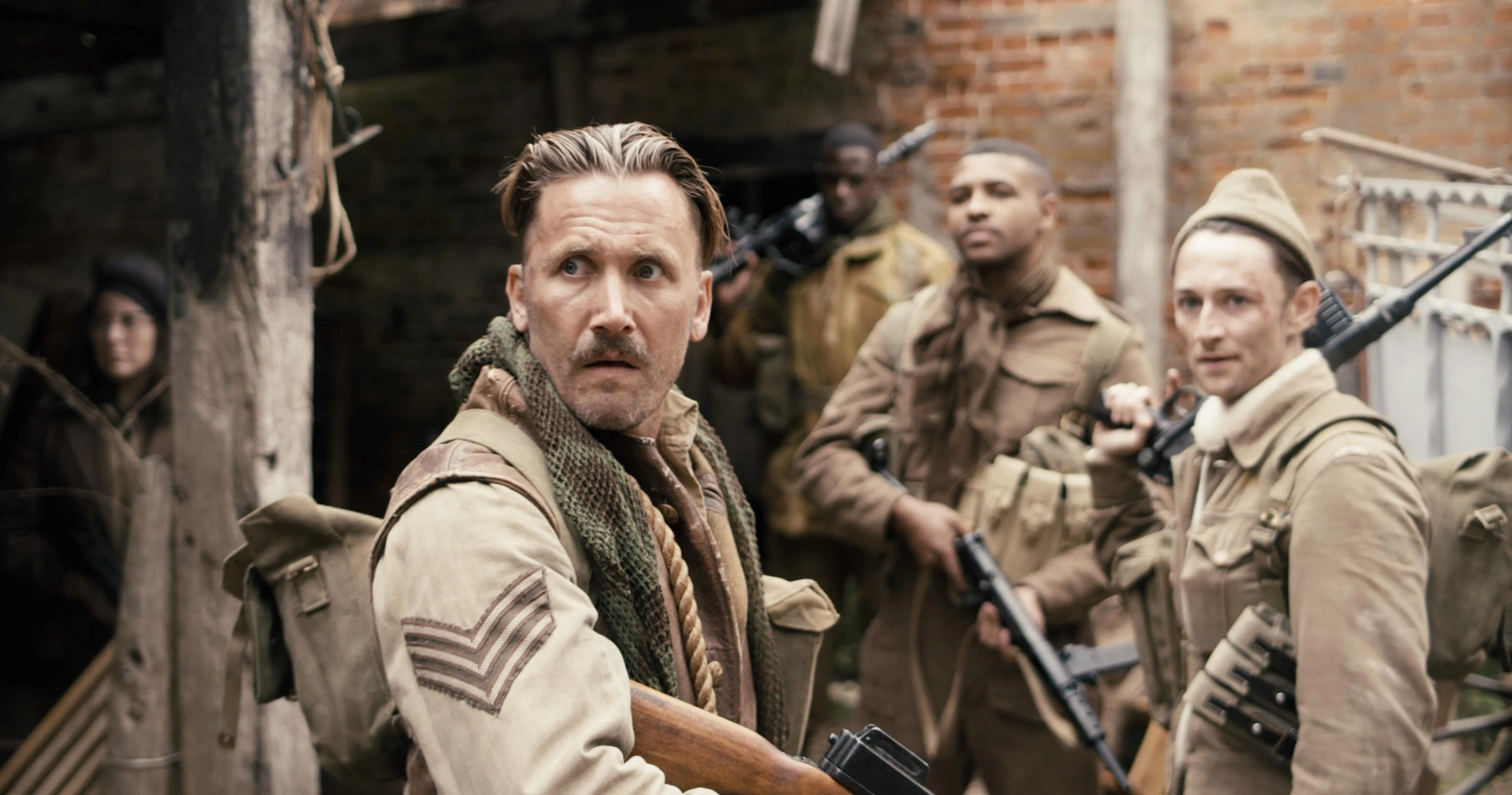 Max Gates, James Oliver Wheatley, Asan N'Jie, and Daniel Thrace in Fortunes of War (2024)